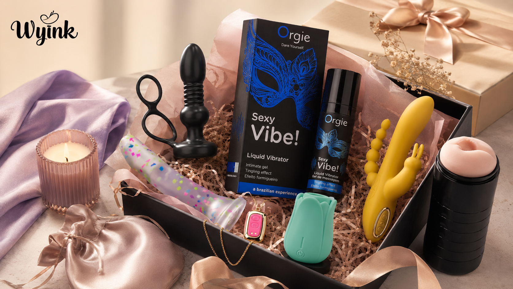 Premium Wyink adult wellness gift set with Orgie Sexy Vibe gel, discreet toys, satin pouch, ribbon, candle, and gift packaging.