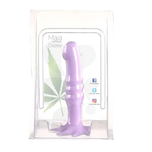 A purple silicone dildo in its clear plastic retail packaging, featuring a printed insert card with the brand name 'Maia' and product name 'Dazey'.