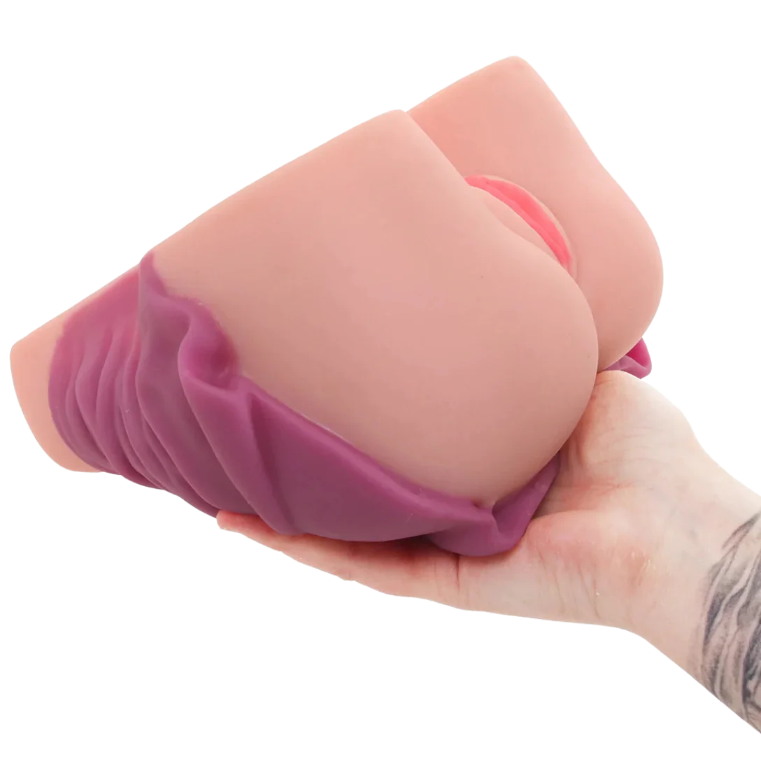A flesh-toned silicone adult novelty item being held in a person's hand against a plain white background.